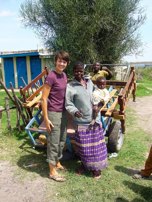 With the volunteer's help, mother of child, Ahdiambo gets a bed in Kenya.