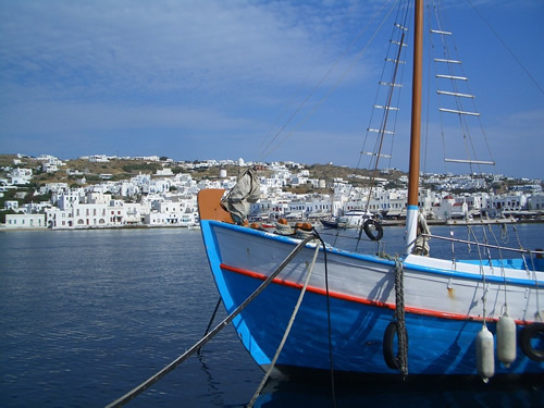 A blue boat moored in the port in Mykonos.