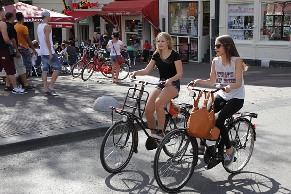 Friends biking in Amsterdam, Netherlands.