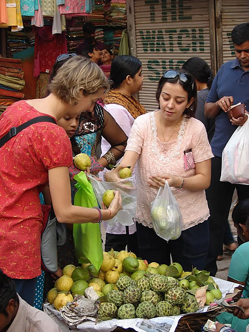 Getting advice from a local in New Delhi about the best guavas. 