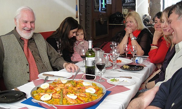 Sharing a paella with friends is one of many enjoyable Spanish rituals.