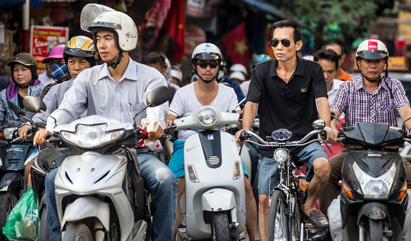 Scooters, motocycles, and bikes coexist in Hanoi