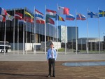 Study abroad to find work with student in front of flags thumbnail.