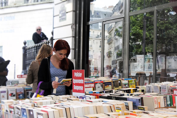 Student checking out books at the many bookstores in Paris.
