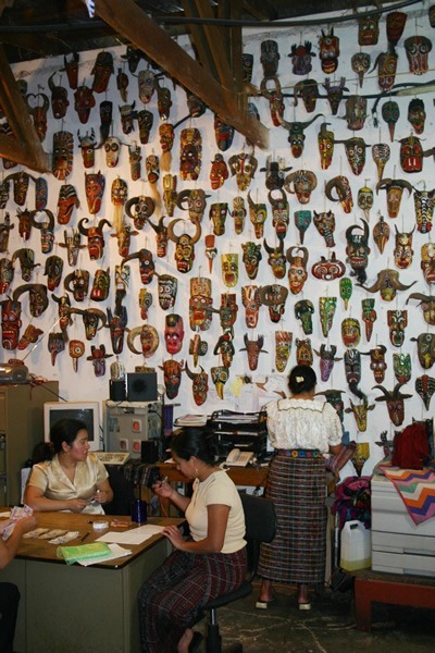 Wall of masks in Guatemala office.