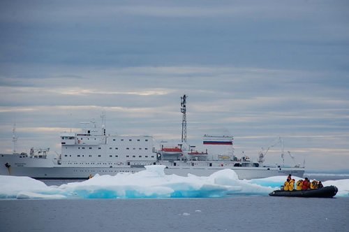 Arctic ship with smaller rubber boat coming ashore.