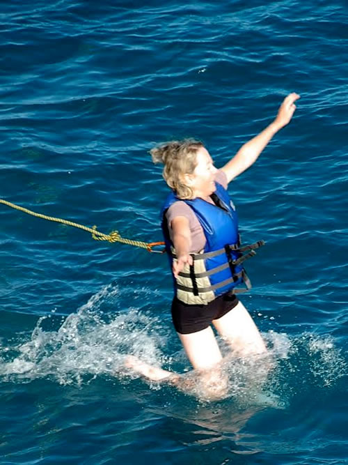 A women taking the plunge into the cold water.