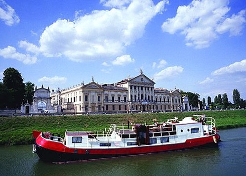 Barge cruise through Venice to experience the Dolce Vita.