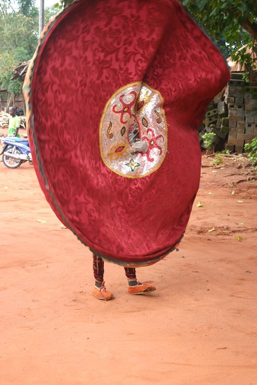 An Egun twirling a robe in Burkina Faso.