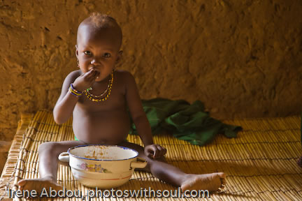 Toddler eats breakfast in bed.