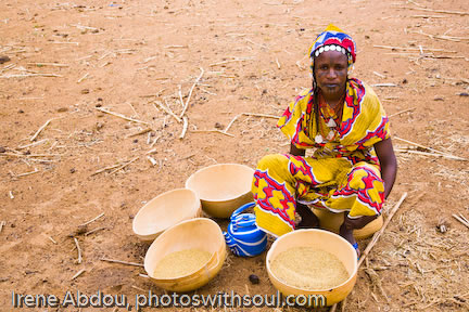 Fulani woman with chaff from grain.