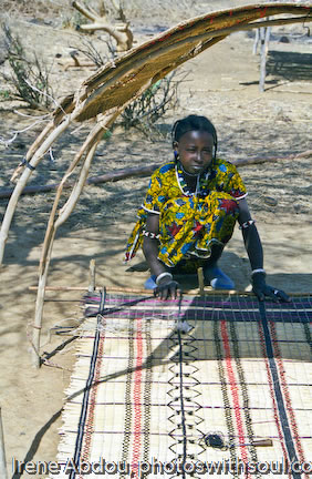 Fulani woman weaves grass mat
