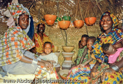 Fulani women socialize inside straw mat hut