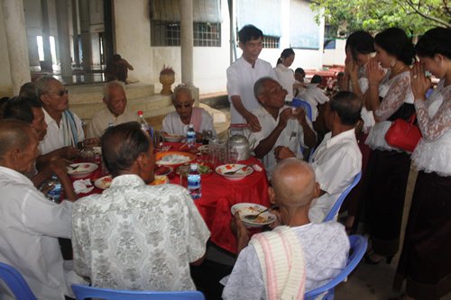 Worshippers dining before a Cambodian Buddhist ceremony.