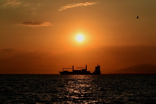 Cargo ship travel with a sunset view
