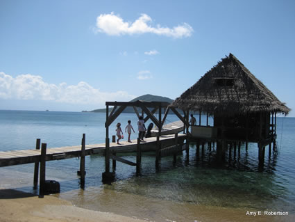 Author's children enjoy the Dock of Cayo Grande island, Honduras.