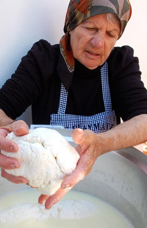 Kneading halloumi portions by hand