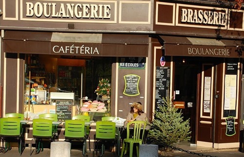 Bakery and cafe in Paris with women outside drinking coffee.