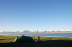 Cycling adventure along a lake with a tent.