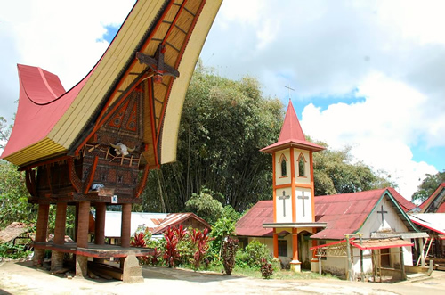 Tongkonan and a Christian church in Sulawesi, Indonesia