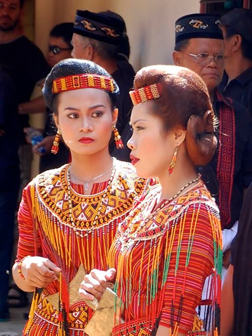 Women in ceremonial dress funeral procession.