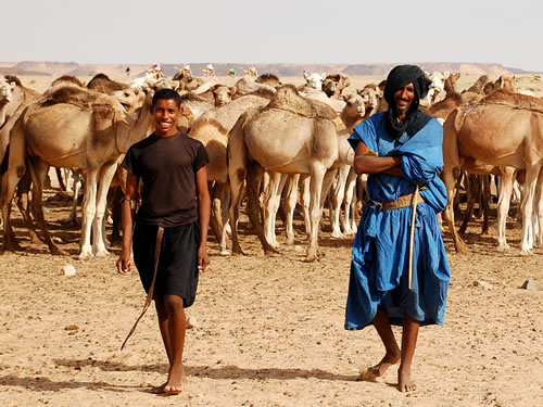 Two male camel herders welcome us.