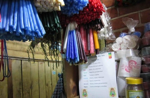 Colorful religious candles at a market.