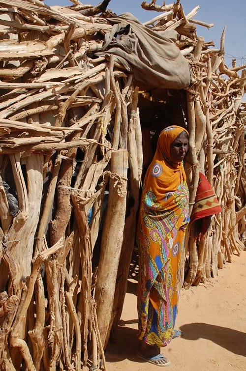 Nomad woman in front of her home made from acacia branches