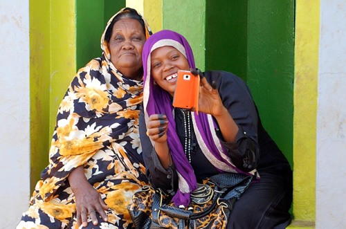 Sufi women with cellphones.