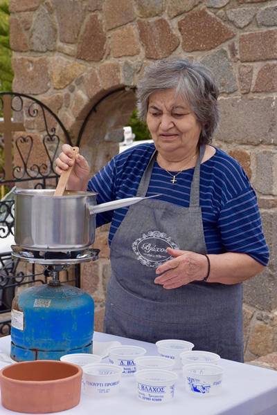 Mrs. Vlachos preparing yogurt from scratch in Paros.