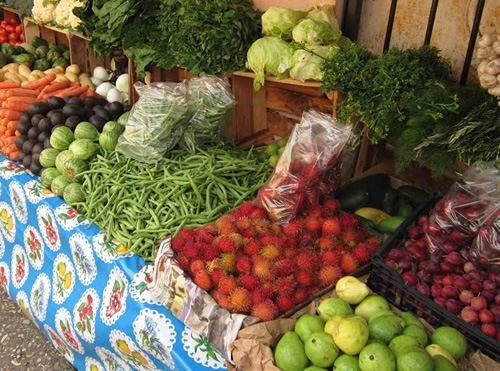 Eating well at markets with beautiful fresh vegetables and fruits on display.