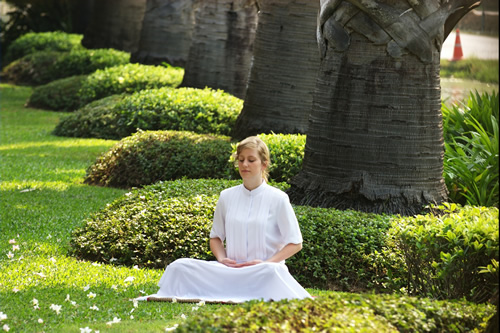 A woman engaged in meditation in Thailand