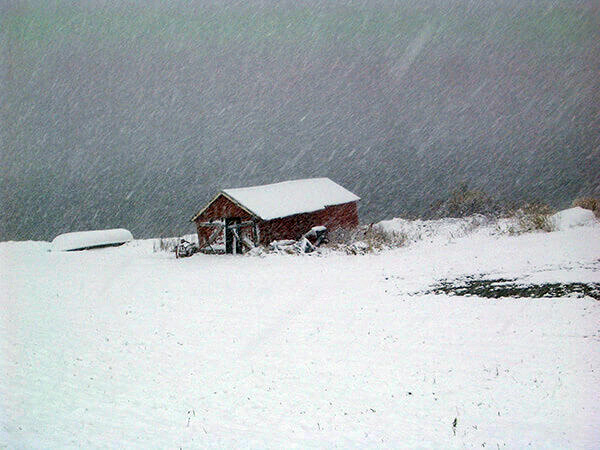 A boat shed covered in snow in northern Norway.