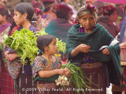 Photo of woman and children in market