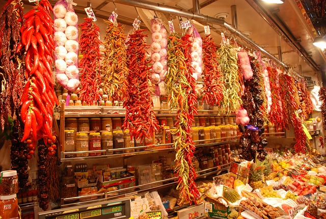 Chilies of all colors, garlic, and more at a stall at La Boqueria market in Barcelona.