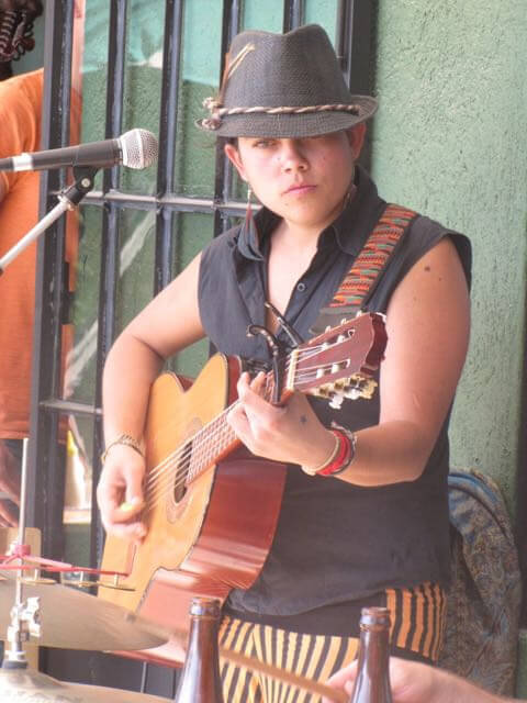 Woman playing guitar and working as a musician.