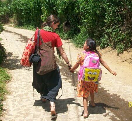 Jobs abroad: A Volunteer walks with a child.