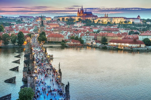 People crossing bridge in Prague