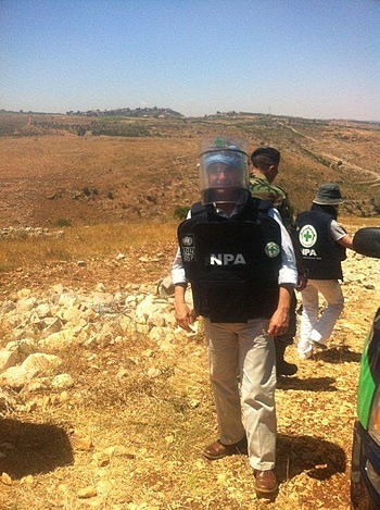 Luca Renda with UNDP Lebanon in a protective suit against landmines.