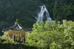 Temple in Taiwan in forest with waterfall.