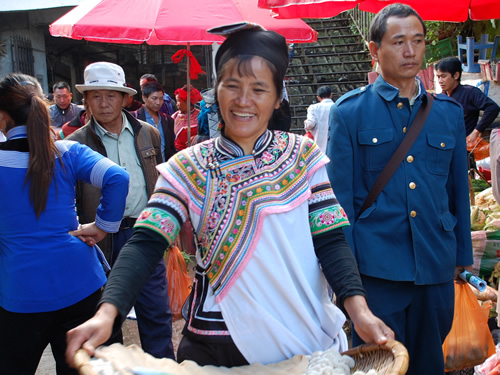 Woman in colorful clothes in a Chinese market.