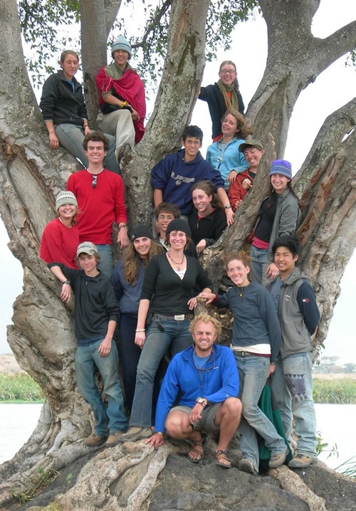 Leading a High School student group while sitting on a tree.