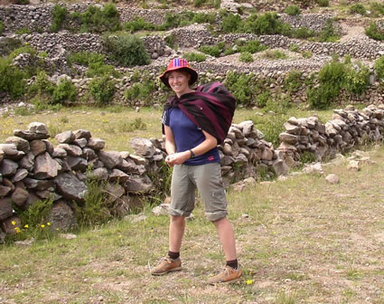 Woman carrying potatoes in a blanket in Argentina.