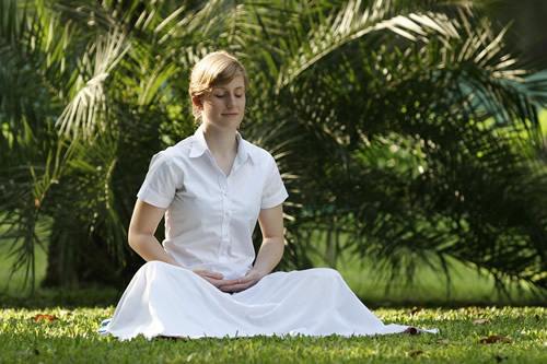 Woman meditating at a Buddhist retreat