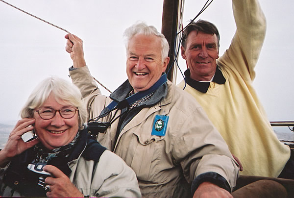 Pilot Lars (right) and ElderTrekkers, Robbie and Liz, relax in the balloon basket while flying high over Cappadocia.