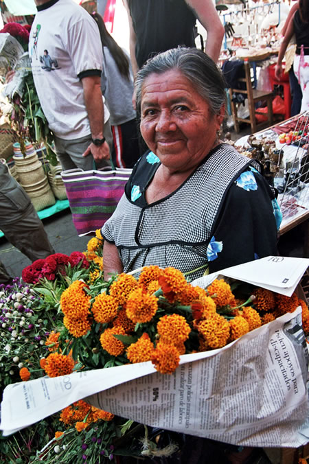 Woman with flowers at market in Oaxaca