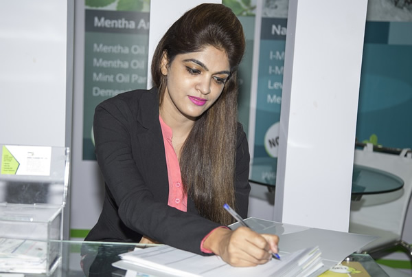 A young professional woman working in an office of an international corporation.