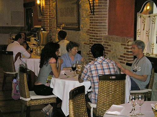 Spaniards and Volunteer Anglos conversing at a meal