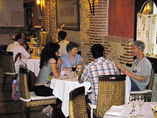 Spaniards and Volunteer Anglos conversing at a meal