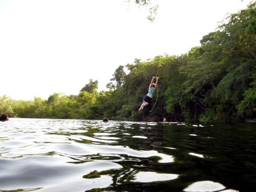 Recreation swinging rope into river water